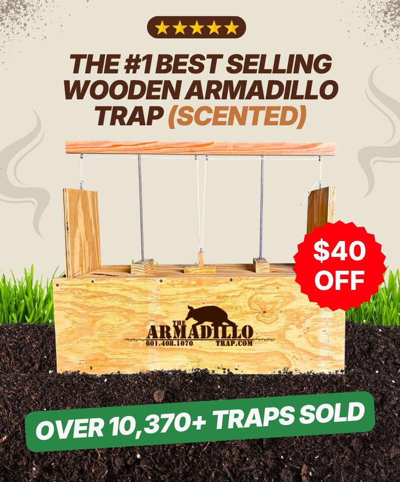 A wooden, humane Armadillo Trap by Armadillo Trap sits on soil with grass behind it. Text reads: "The #1 Best Selling Scented Wooden Armadillo Trap", "$40 off", and "Over 10,370+ traps sold." Brand logo visible.