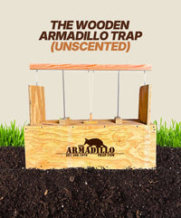 An Unscented Wooden Armadillo Trap by Armadillo Trap, featuring a logo and contact info, rests on soil before green grass. Bold text above says, "UNSCENTED WOODEN ARMADILLO TRAP," ideal for effective armadillo control or expert guidance.