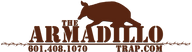 Logo for "The Armadillo Trap" featuring a silhouette of an armadillo above large, bold text. The contact number "601.408.1070" and website "TRAP.COM" appear below, with barbed wire graphics on each side.